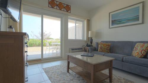 a living room with a couch and a table at Sea Crest in Amagansett