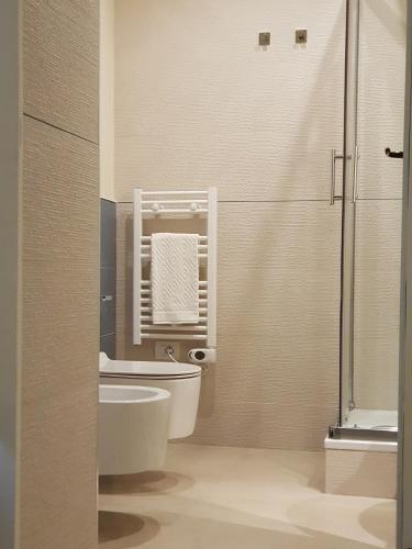 a bathroom with a toilet and a sink and a shower at MammaDada charm rooms in Bari
