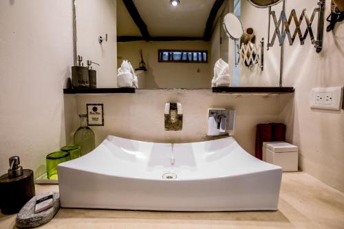 a white bath tub sitting in a kitchen at Alma Tulum Hotel Boutique in Tulum