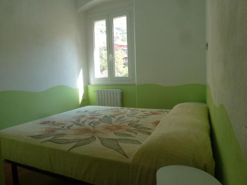 a bedroom with a bed with a flower on it at Riomaggiore Attico in Riomaggiore