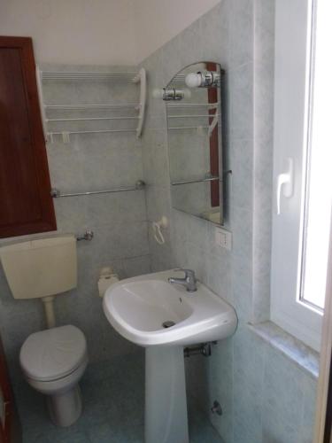 a bathroom with a white sink and a toilet at Riomaggiore Attico in Riomaggiore