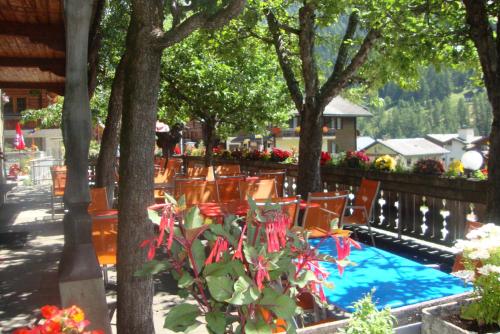 a group of chairs and a swimming pool with trees at Bietschhorn in Kippel