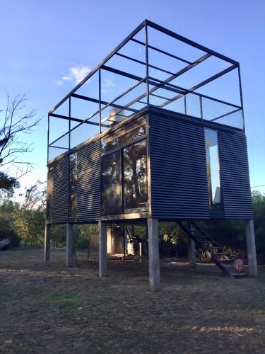 a house is on display in a field at Cabañas Isla San Jose in Tigre