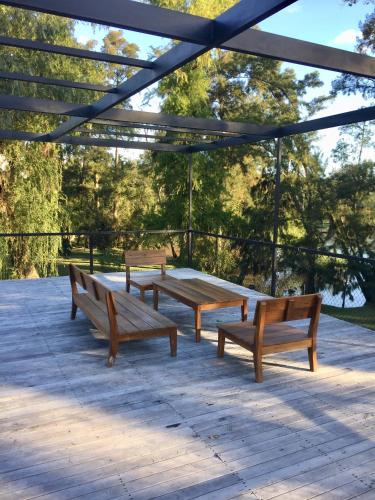 a group of benches sitting on a patio at Cabañas Isla San Jose in Tigre