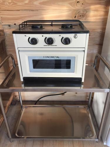 a stove sitting on a cart in a kitchen at Cabañas Isla San Jose in Tigre