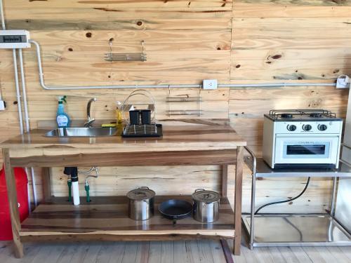 a kitchen with a sink and a stove at Cabañas Isla San Jose in Tigre