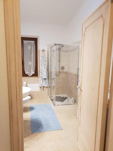 a bathroom with a shower and a toilet and a sink at Appartamento " CENTRAL" in Arzachena