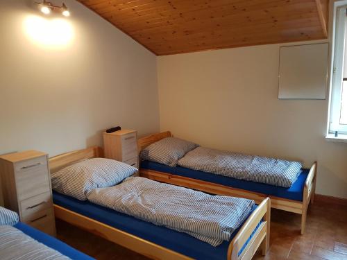 a room with three beds and a window at Noclegi Silesia ASTER in Tychy