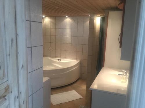 a bathroom with a tub and a toilet and a sink at Cozy room in Kolding