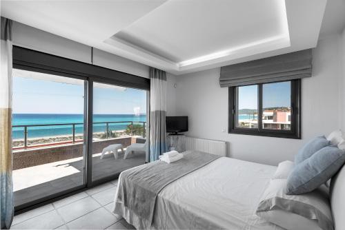 a bedroom with a bed and a view of the ocean at Possidi Villa Glamour by Luxlikehome in Possidi