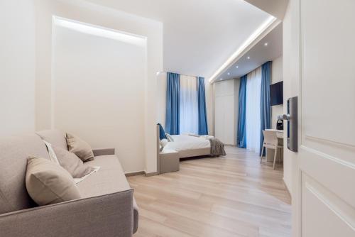 a living room with a couch and a bedroom at Alchimia di Mare in La Spezia