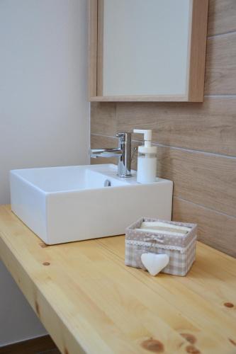 a bathroom sink on top of a wooden table at Co.Me 563 in Dolo