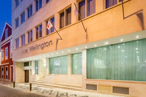 a building with a sign on the side of it at EXE Wellington in Figueira da Foz