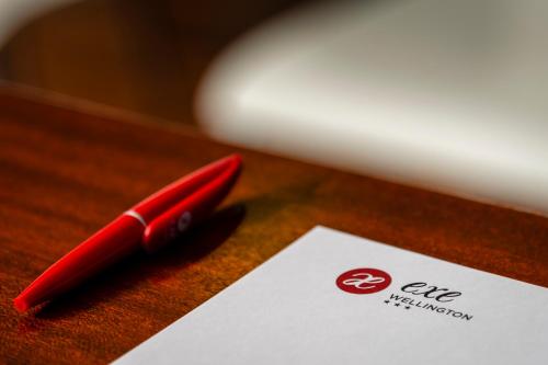 a red pen sitting on top of a piece of paper at EXE Wellington in Figueira da Foz