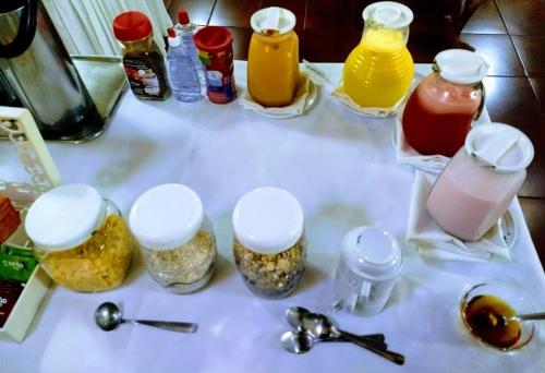 a table with jars of food and condiments on it at Vila Verde Hotel in Toledo