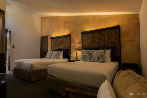 Tempat tidur dalam kamar di Hotel Ciudad Vieja
