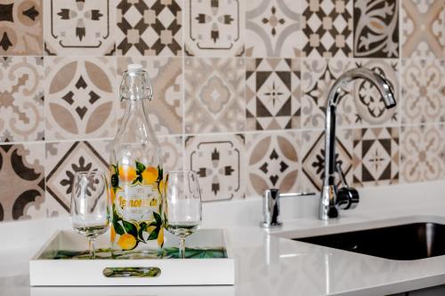 two wine glasses sitting on a counter next to a sink at Casa Rural Peña Gamella in Herreros