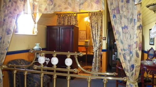 a room with a chair and a mirror at A Pilgrims Rest in Graskop