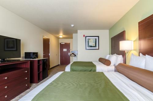 a hotel room with two beds and a flat screen tv at Cobblestone Inn & Suites - Ord in Ord