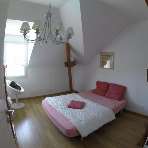 une chambre avec un lit et un lustre dans l'établissement Villa du Courboulay, à Sargé Les Le Mans 