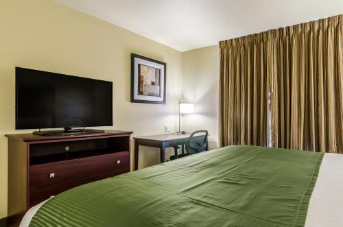 a hotel room with a bed and a flat screen tv at Cobblestone Inn & Suites - Ord in Ord