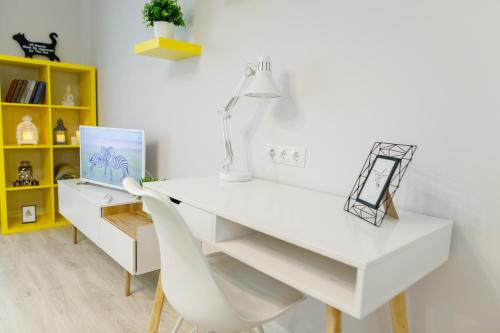a white desk with a chair and a laptop at Apart-Hotel "LAVINA" in Sumy
