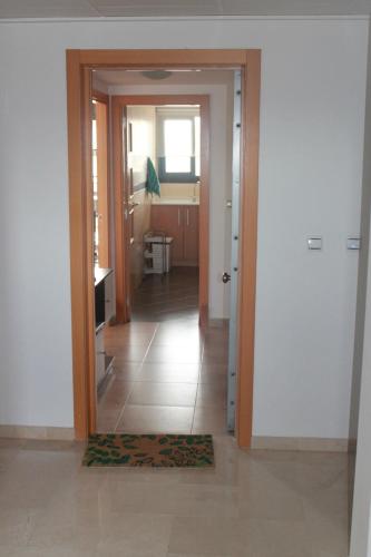 a hallway with a door leading to a kitchen at Panorámica Golf San Jordi in San Jorge
