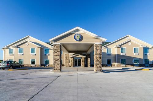 a building with a clock on the front of it at Cobblestone Inn & Suites - Ord in Ord
