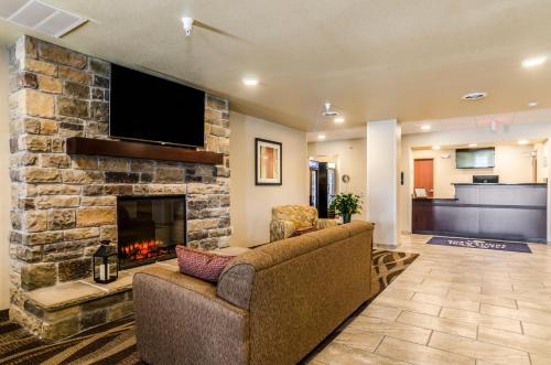 a living room with a couch and a fireplace at Cobblestone Inn & Suites - Ord in Ord