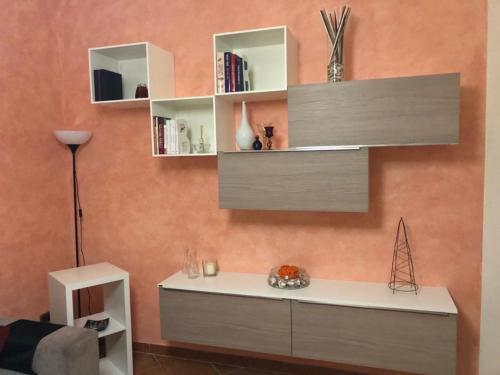 a room with a desk and shelves on a wall at A Casa Di Tina in Cassino