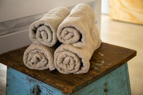 a pile of towels sitting on top of a wooden table at the STUDIO apartment in Durbanville in Durbanville