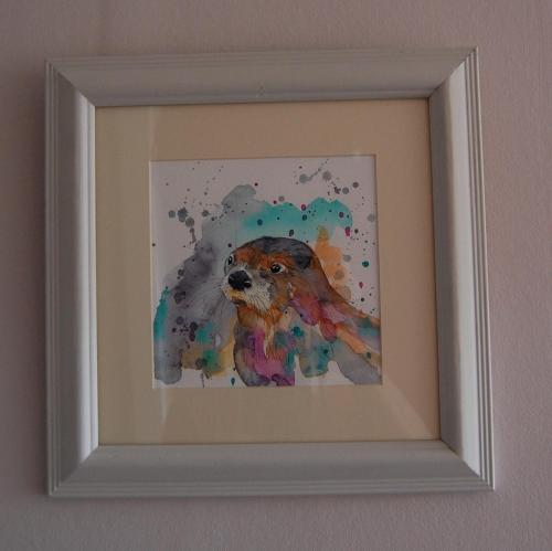 a painting of a dog in a frame on a wall at Glenelg in Tobermory