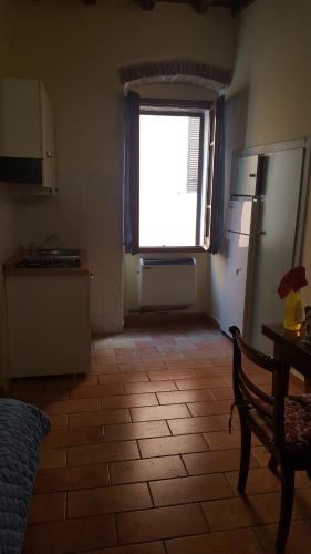 a kitchen with a large window and a kitchen with a table at Via della Posterna in Spoleto