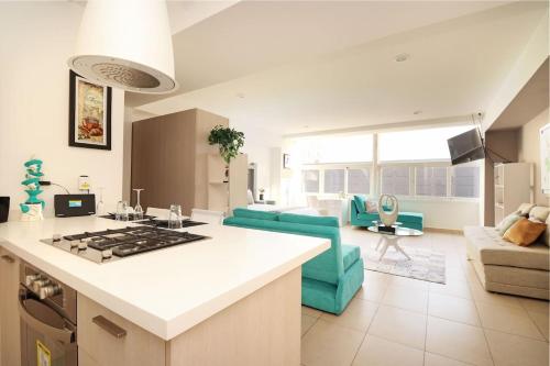 a kitchen and living room with a couch and a table at Premier apartment in the heart of Mexico 802 in Mexico City