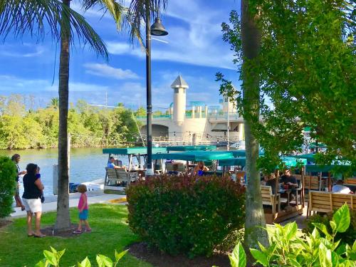a group of people standing in a park near the water at Seashell 2 in Boynton Beach
