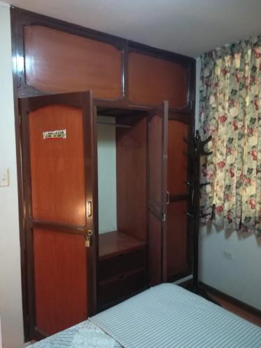 1 dormitorio con litera y puerta con espejo en Mini Departamento Tambo Huascar 2, en Lima