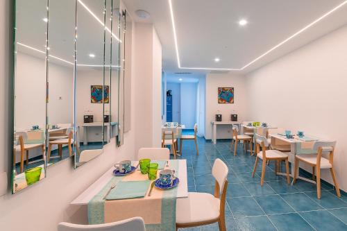 a dining room with tables and chairs and a cafeteria at Casa Dolce Casa Ravello in Ravello