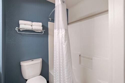 a bathroom with a white shower curtain and a toilet at Extended Stay America Suites - Charlotte - University Place in Charlotte