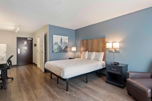 a hotel room with a bed and a couch at Extended Stay America Suites - Charlotte - University Place in Charlotte