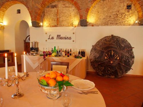 a table with a bowl of fruit on top of it at Il Borgo Country Resort in Castiglione di Sicilia