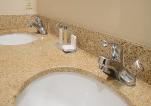 a bathroom counter with two sinks and two faucets at Bell Rock Inn in Sedona