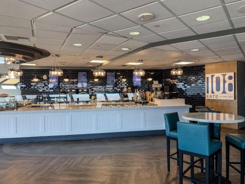 a restaurant with tables and chairs and a bar at The STRAT Hotel, Casino & Tower in Las Vegas