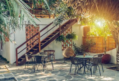 a patio with tables and chairs and a staircase at Villa Eden Palomino in Palomino