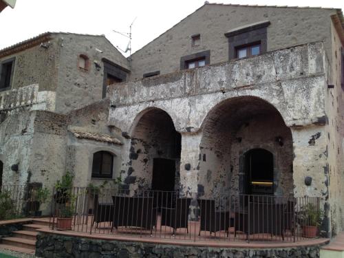an old stone building with an archway in front of it at Il Borgo Country Resort in Castiglione di Sicilia