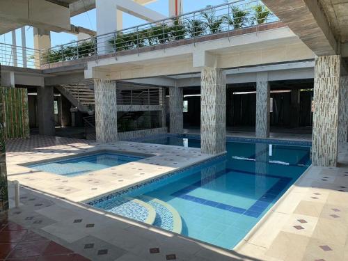 a large swimming pool in a building at Mirador de San Jorge in Girardot