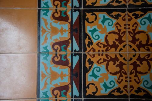 a tiled wall with a pattern of animals on it at Verde Morada in Valladolid