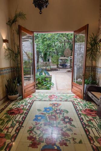an open door to a room with a mosaic floor at Verde Morada in Valladolid