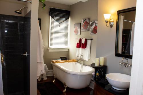 a bathroom with a white tub and a sink at The Katherine Holle House in Watertown