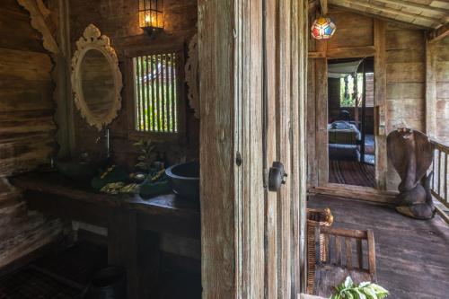 an open door to a room in a log cabin at Ratua Private Island Resort in Aimbuei Bay