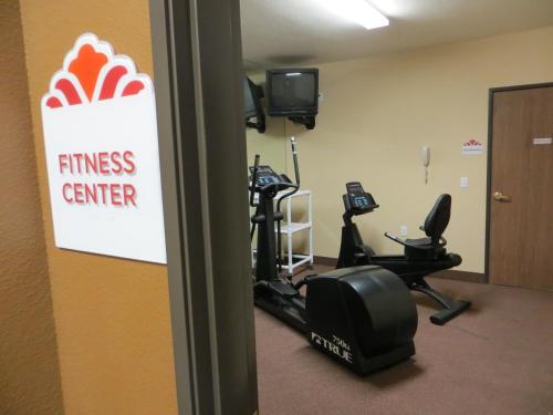 a fitness center with tread machines and a sign on the wall at Hawthorn Suites Las Vegas in Las Vegas